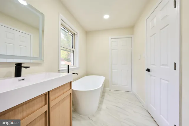 a view of a kitchen with a refrigerator sink and cabinets