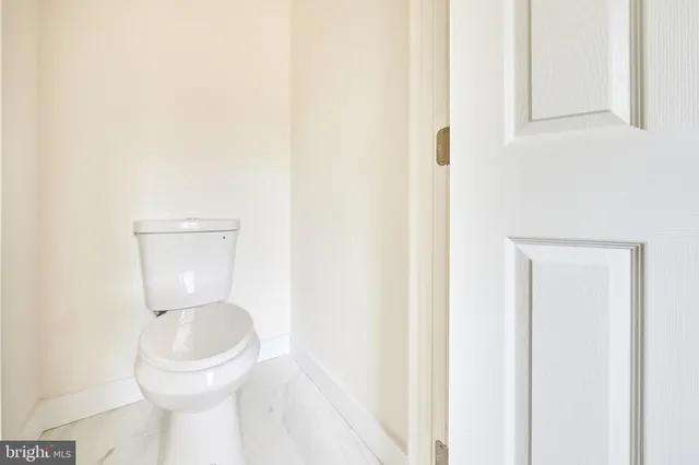 a white toilet sitting next to a bathroom sink