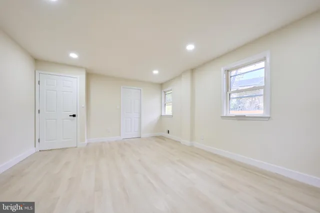 a view of a kitchen with white cabinets and a sink