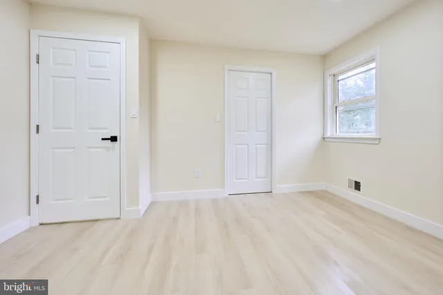 a view of a kitchen with a refrigerator sink and cabinets