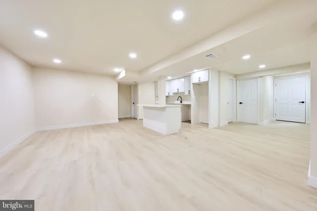a view of an empty room with a window and fireplace