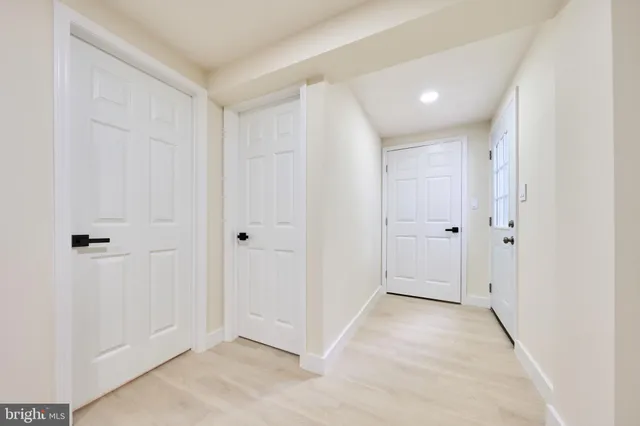 a view of entryway and hall with wooden floor