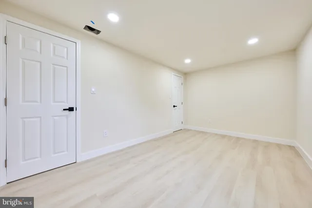 a large kitchen with kitchen island a sink dishwasher a stove and a refrigerator with wooden floor