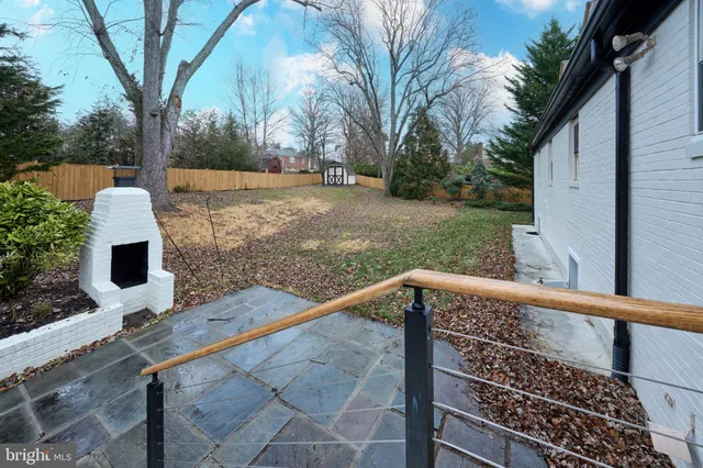 a view of a house with a backyard and a patio