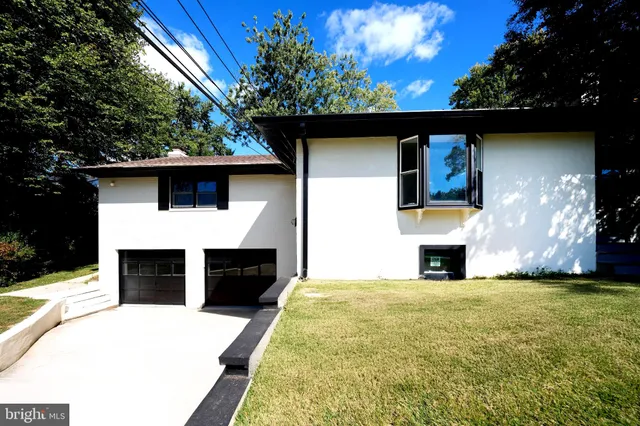 a view of empty room with fireplace and windows