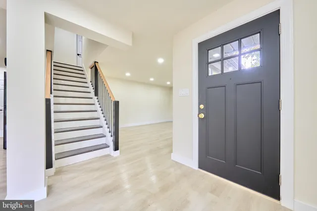 a kitchen with stainless steel appliances kitchen island granite countertop a sink refrigerator and cabinets