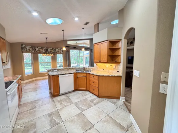 a large kitchen with a large counter top and stainless steel appliances
