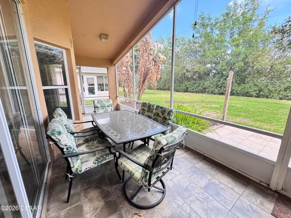 a view of a patio with a table chairs and backyard