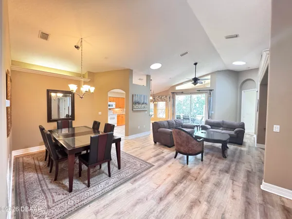 a view of a dining room with furniture window and wooden floor