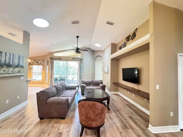 a living room with furniture and a flat screen tv