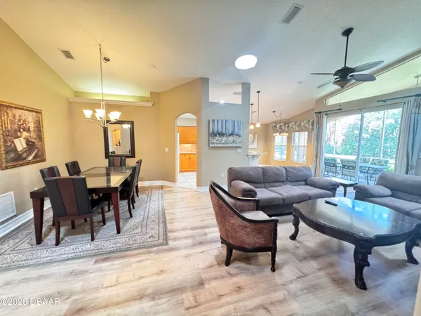 a living room with furniture and a chandelier