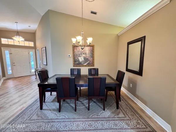 a view of a dining room with furniture and wooden floor