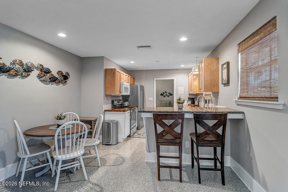 5437 3rd Street St. Augustine, FL 32080 - Photo 12 of 35 a view of a dining room with furniture and a livingroom