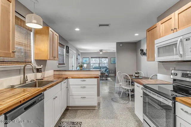 a kitchen with a sink stove and cabinets