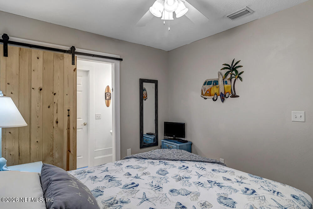 5437 3rd Street St. Augustine, FL 32080 - Photo 23 of 35 a bedroom with a bed and a television
