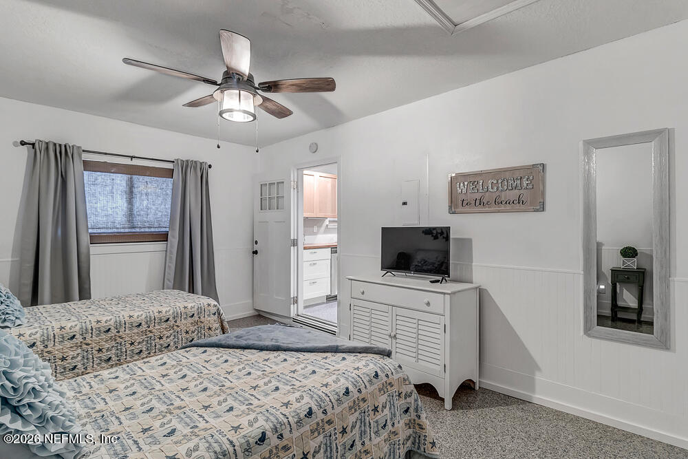 5437 3rd Street St. Augustine, FL 32080 - Photo 27 of 35 a bedroom with a bed and a flat screen tv