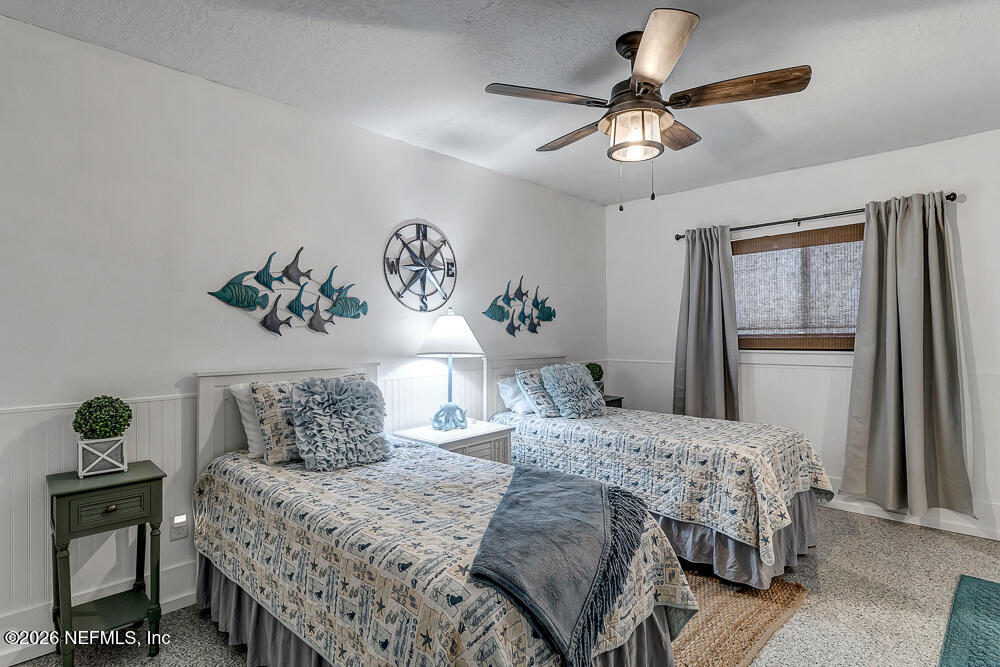 5437 3rd Street St. Augustine, FL 32080 - Photo 28 of 35 a bedroom with a bed and a chandelier