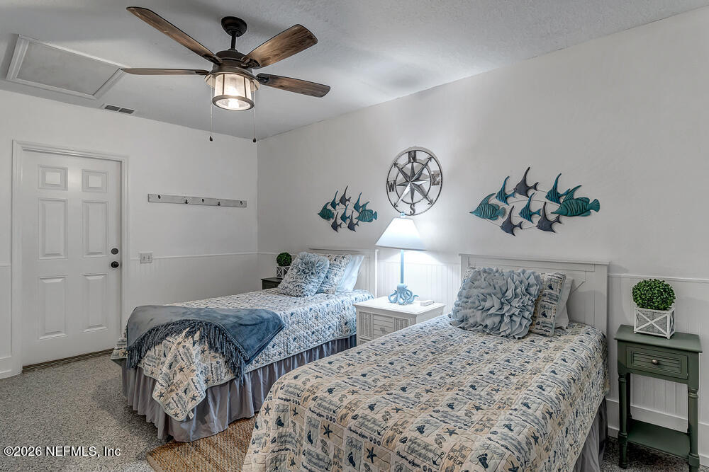 5437 3rd Street St. Augustine, FL 32080 - Photo 29 of 35 a bedroom with two beds and a table