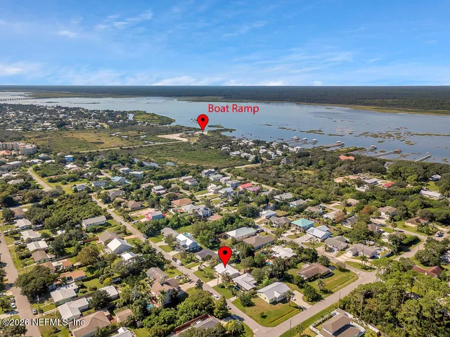 an aerial view of residential houses with outdoor space and street view