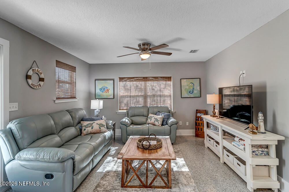 5437 3rd Street St. Augustine, FL 32080 - Photo 7 of 35 a living room with furniture a flat screen tv and a window