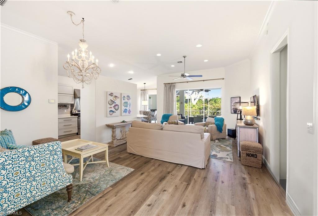 1777 Marsh Run Naples, FL 34109 - Photo 11 of 34 a living room with furniture and a chandelier