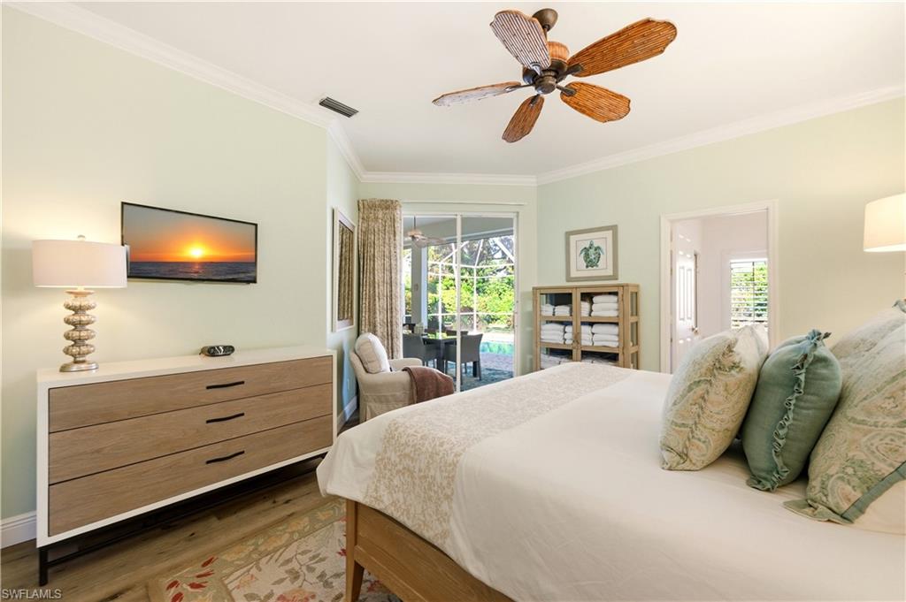 1777 Marsh Run Naples, FL 34109 - Photo 16 of 34 a bedroom with a bed and a flat screen tv