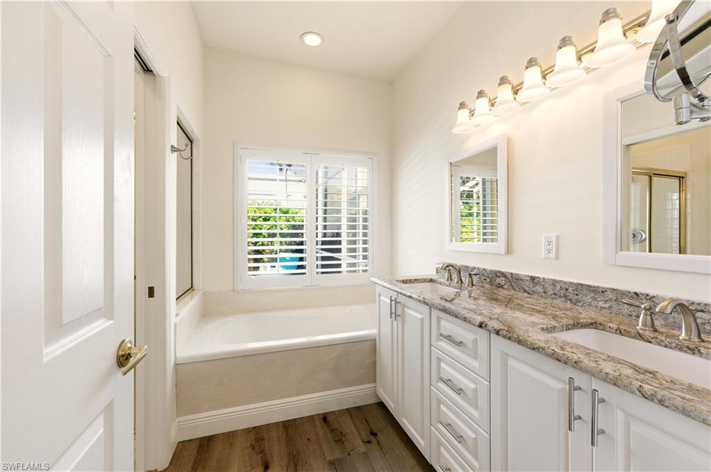 1777 Marsh Run Naples, FL 34109 - Photo 18 of 34 a spacious bathroom with a granite countertop tub sink and mirror