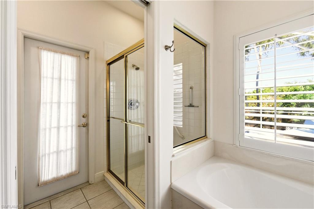 1777 Marsh Run Naples, FL 34109 - Photo 19 of 34 a bathroom with a tub and shower