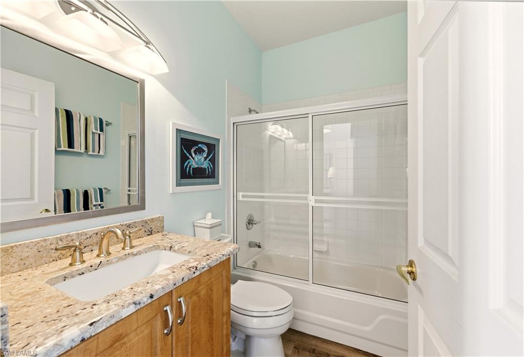 1777 Marsh Run Naples, FL 34109 - Photo 21 of 34 a bathroom with a granite countertop sink toilet and shower