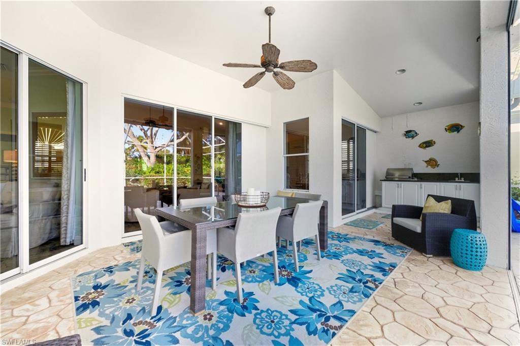 1777 Marsh Run Naples, FL 34109 - Photo 22 of 34 a dining room with wooden floor and a chandelier