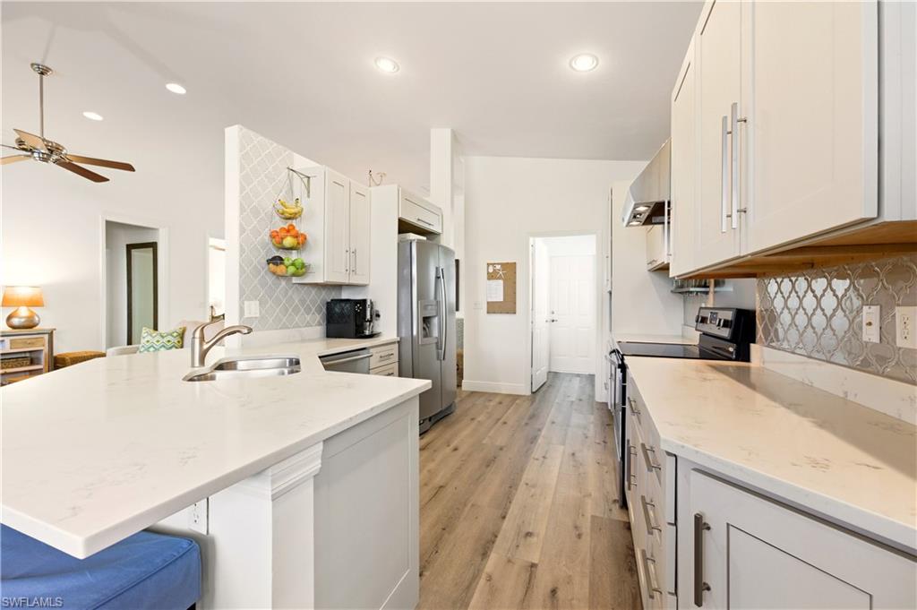 1777 Marsh Run Naples, FL 34109 - Photo 6 of 34 a kitchen with a sink stove and refrigerator