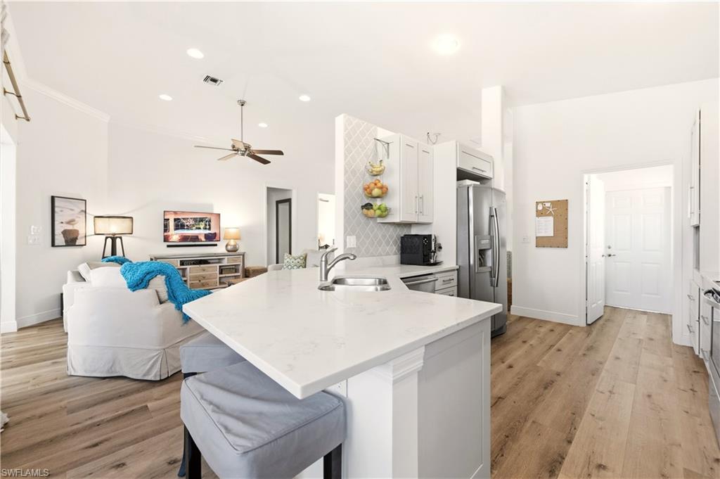 1777 Marsh Run Naples, FL 34109 - Photo 7 of 34 a large kitchen with a table and chairs