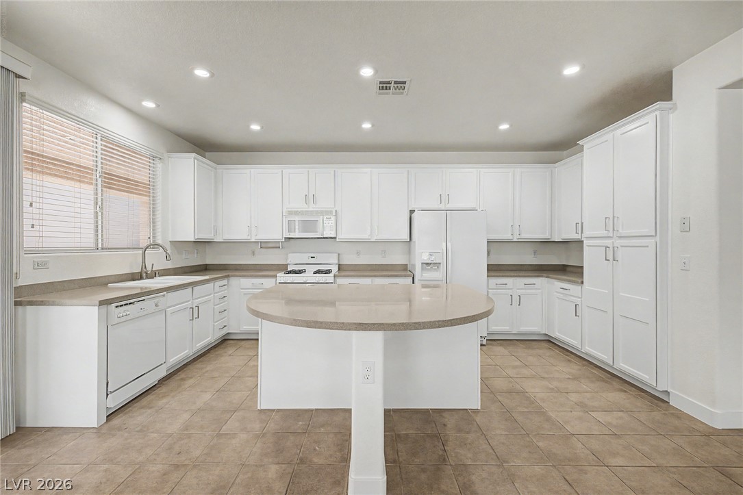 835 Entrada Ridge Avenue Henderson, NV 89012 - Photo 9 of 34 A well-appointed kitchen showcasing an inviting island and generous cabinet storage.