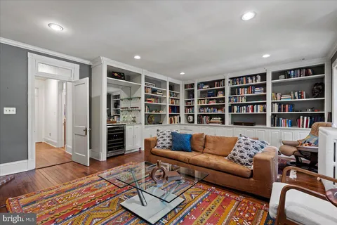 a living room with furniture wooden floor and a flat screen tv