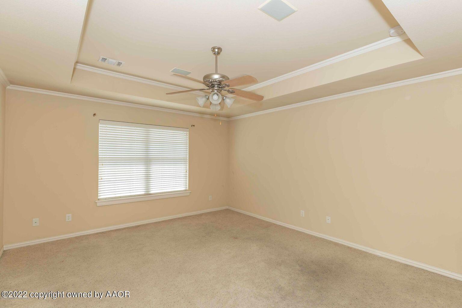 5801 South Rusk Street Amarillo, TX 79118 - Photo 13 of 27 an empty room with a window and a fan