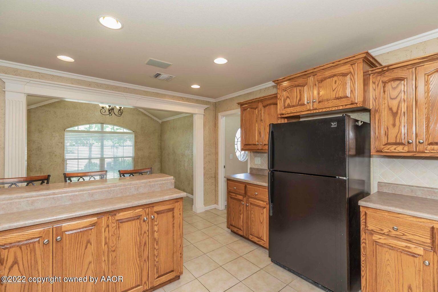 5801 South Rusk Street Amarillo, TX 79118 - Photo 8 of 27 a kitchen with refrigerator a sink and cabinets