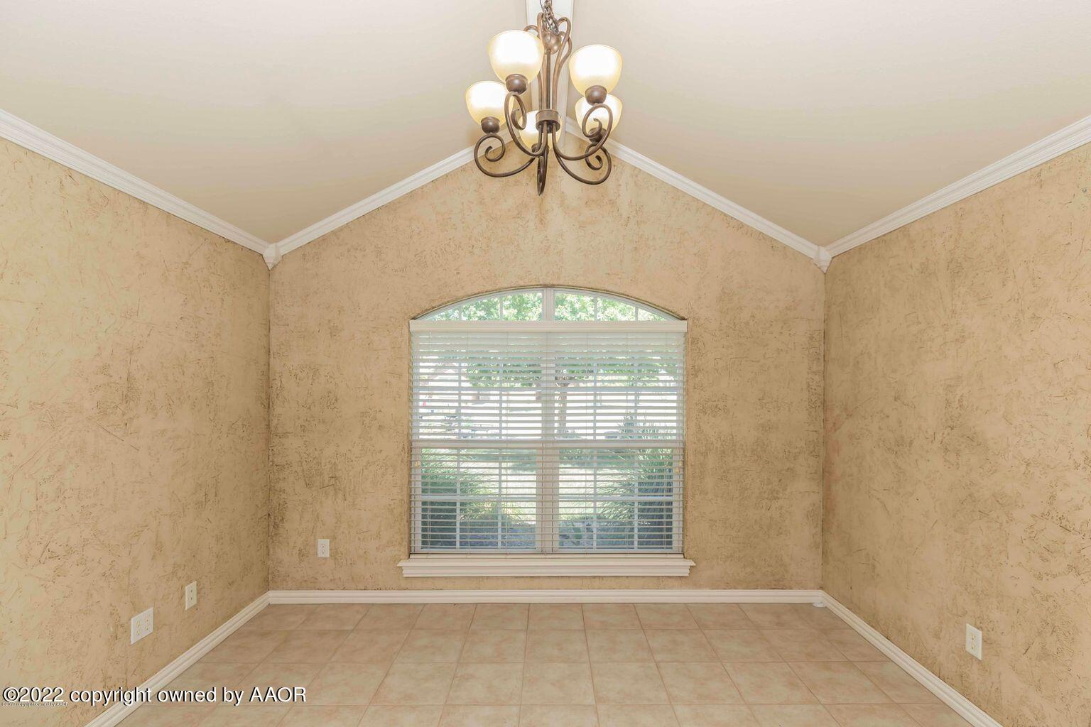 5801 South Rusk Street Amarillo, TX 79118 - Photo 9 of 27 a view of a room with a large window and chandelier
