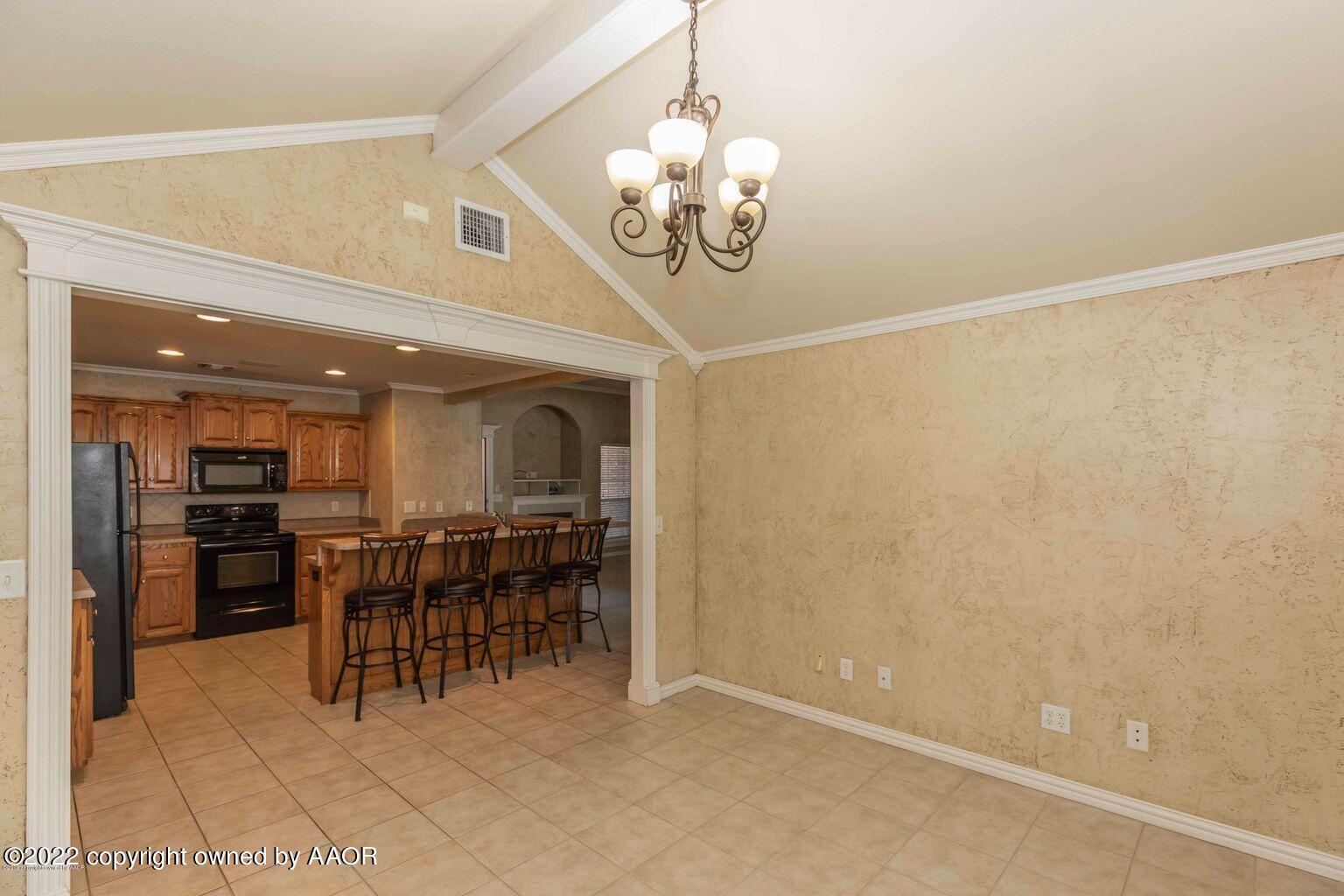 5801 South Rusk Street Amarillo, TX 79118 - Photo 10 of 27 a dining room with furniture and chandelier