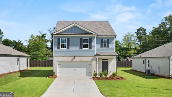 a front view of a house with a yard