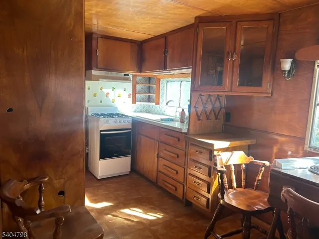 a kitchen with granite countertop a sink and a stove