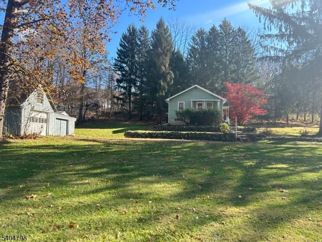a front view of a house with a big yard
