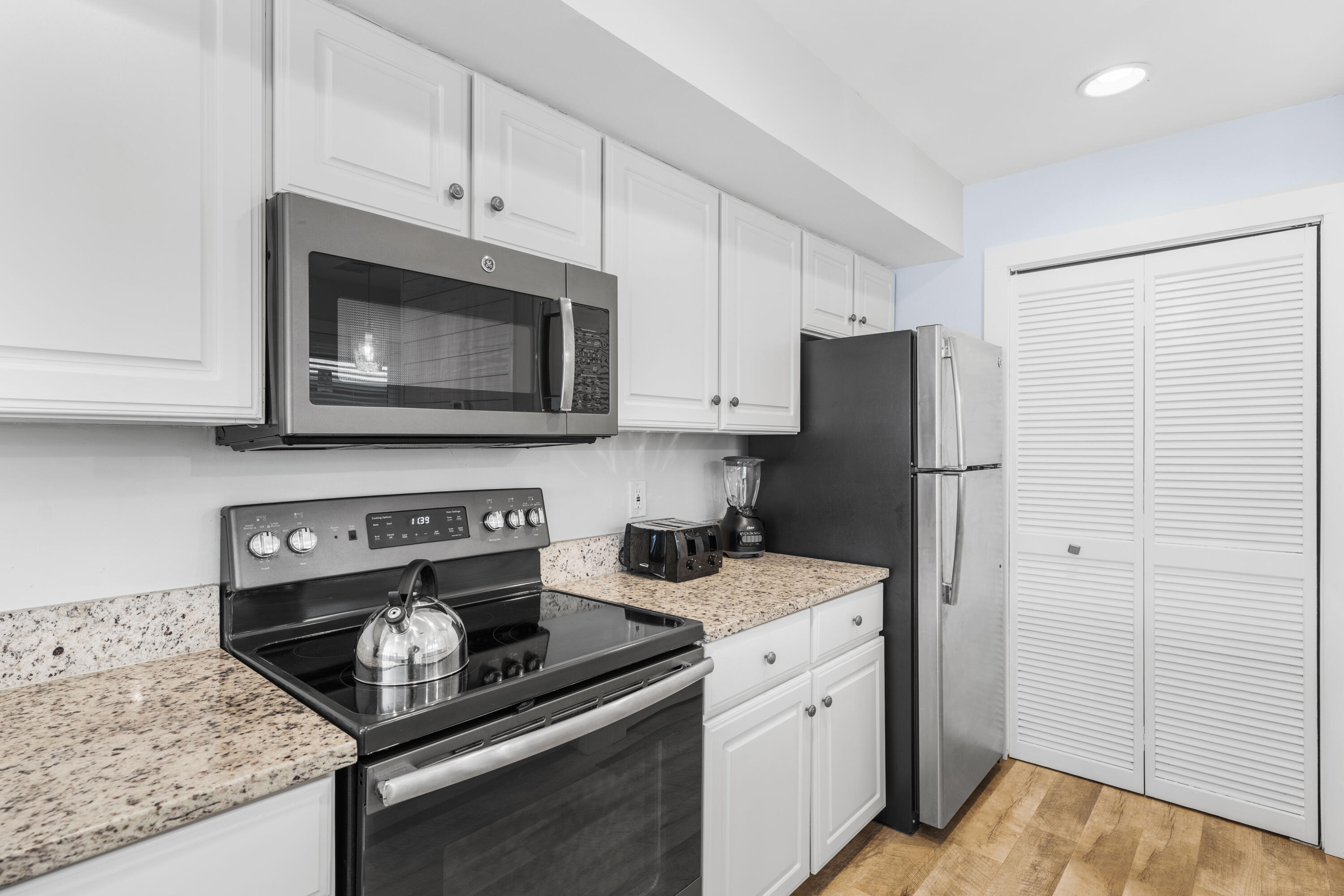 911 Harbour Point Lane, Unit 911 Miramar Beach, FL 32550 - Photo 12 of 40 a kitchen with stainless steel appliances granite countertop a refrigerator stove and microwave