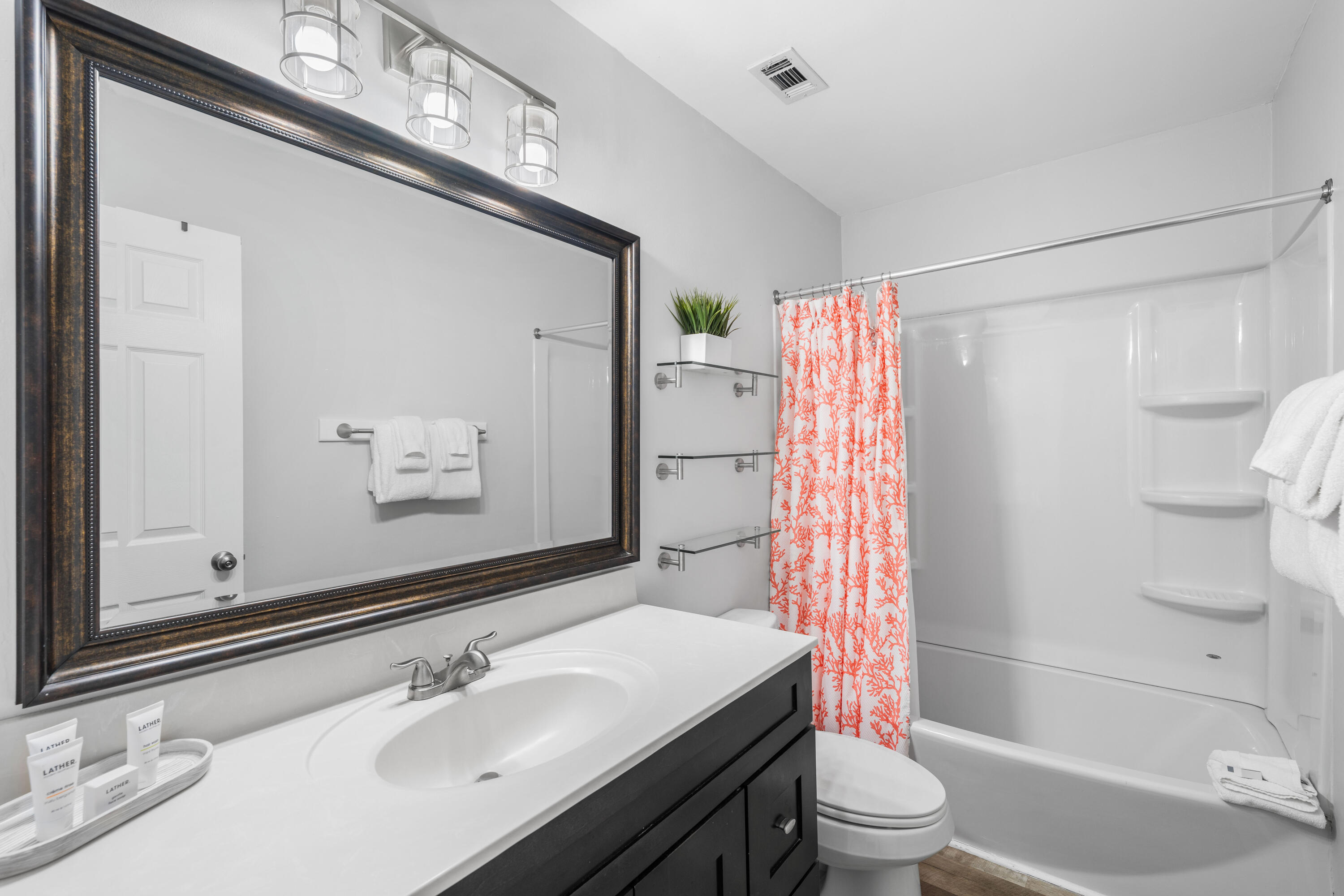 911 Harbour Point Lane, Unit 911 Miramar Beach, FL 32550 - Photo 14 of 40 a bathroom with a sink toilet and shower