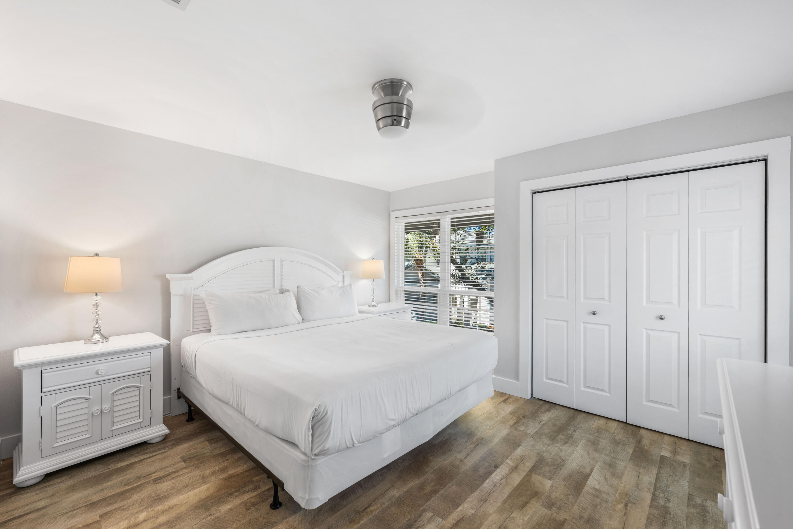 911 Harbour Point Lane, Unit 911 Miramar Beach, FL 32550 - Photo 17 of 40 a bedroom with a large bed and a night stand