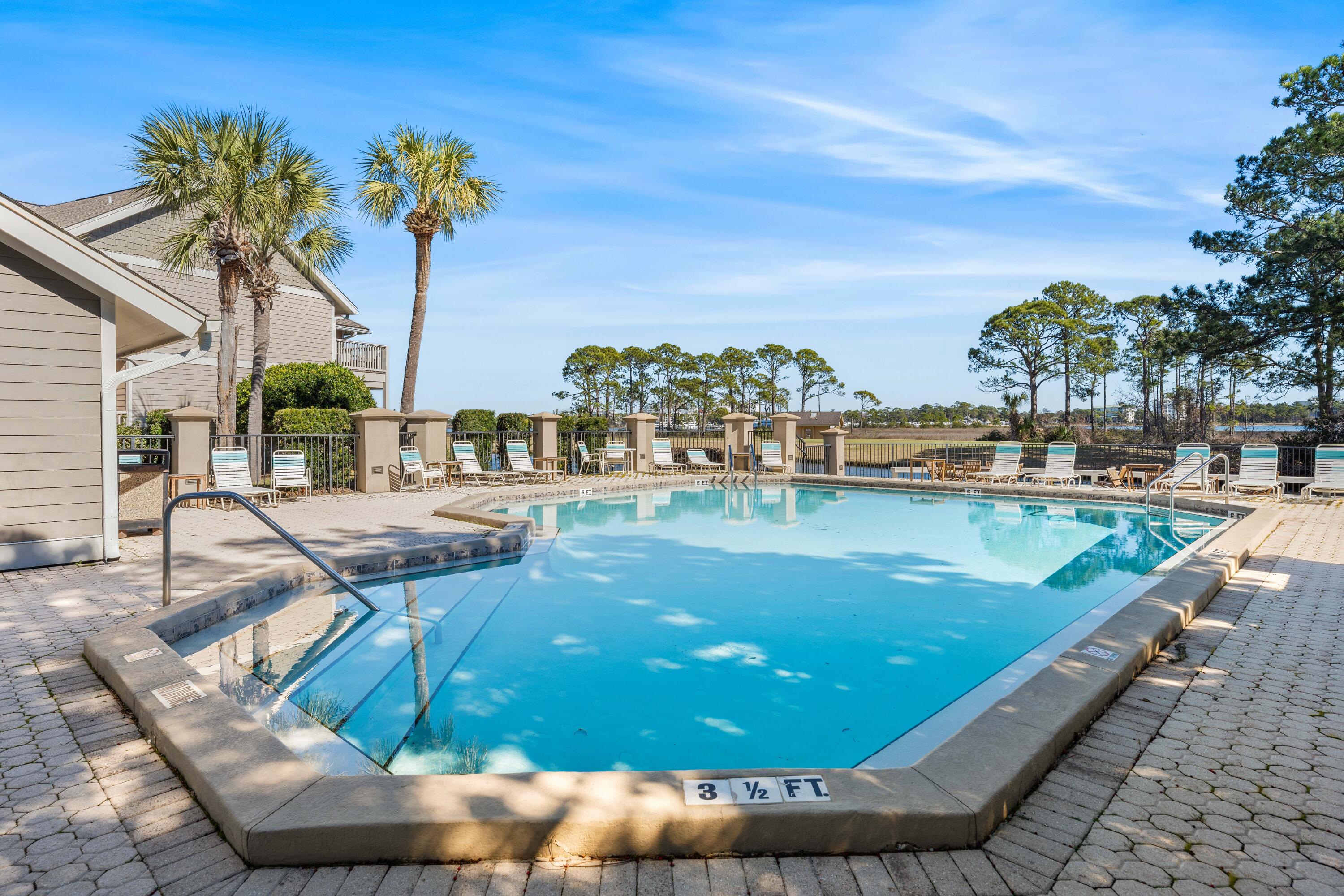 911 Harbour Point Lane, Unit 911 Miramar Beach, FL 32550 - Photo 24 of 40 a view of a swimming pool with a lounge chairs