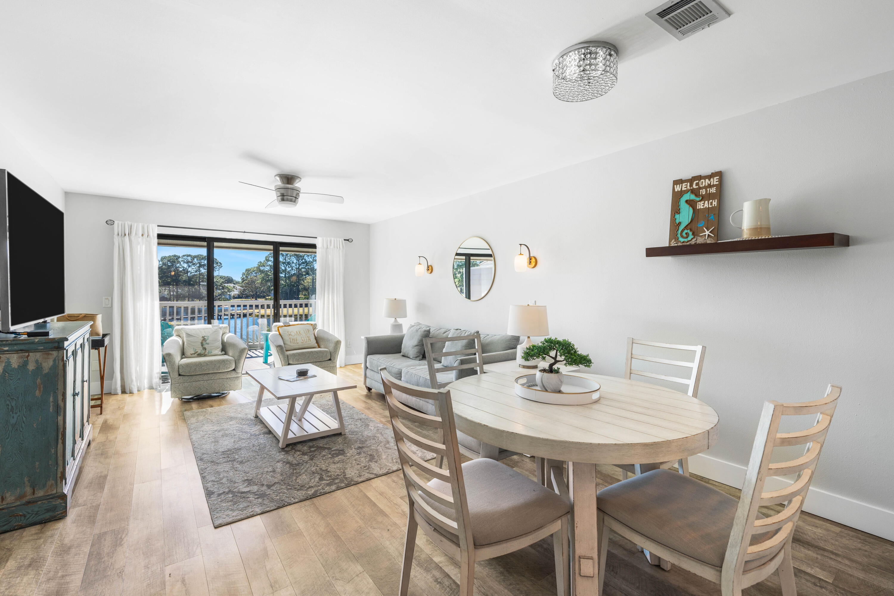 911 Harbour Point Lane, Unit 911 Miramar Beach, FL 32550 - Photo 5 of 40 a dining room with furniture wooden floor and a rug