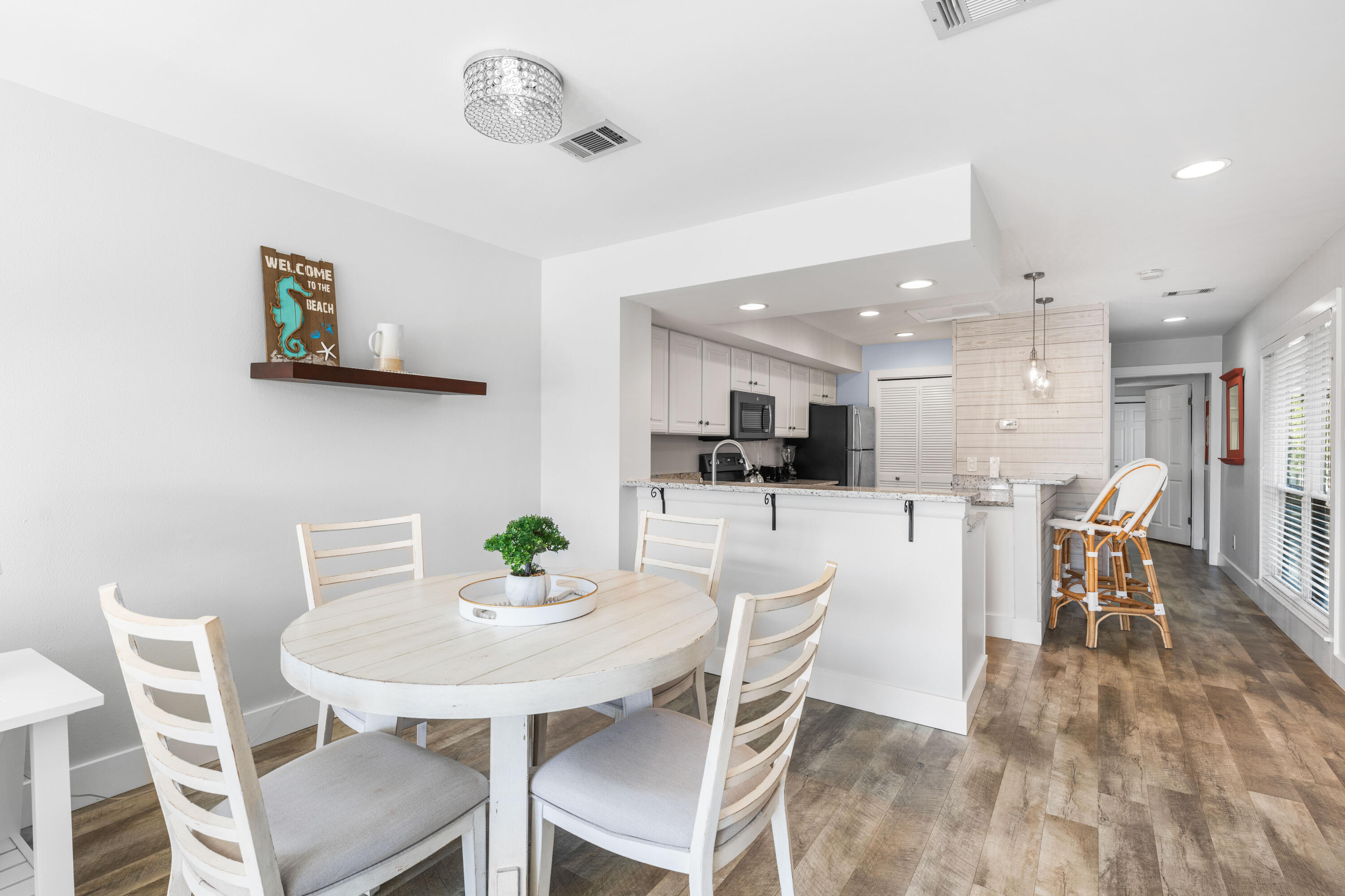 911 Harbour Point Lane, Unit 911 Miramar Beach, FL 32550 - Photo 6 of 40 a view of a dining room with furniture and wooden floor