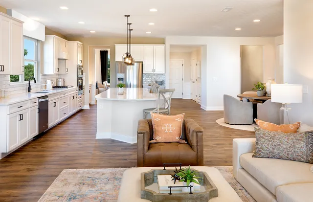a living room with furniture kitchen and a table