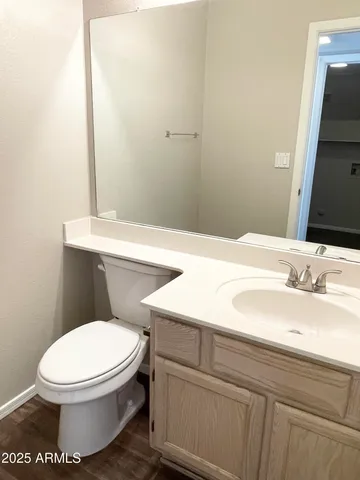 a bathroom with a sink a toilet and mirror
