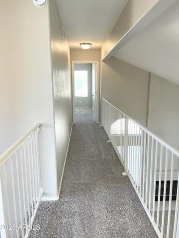 a view of a hallway with staircase